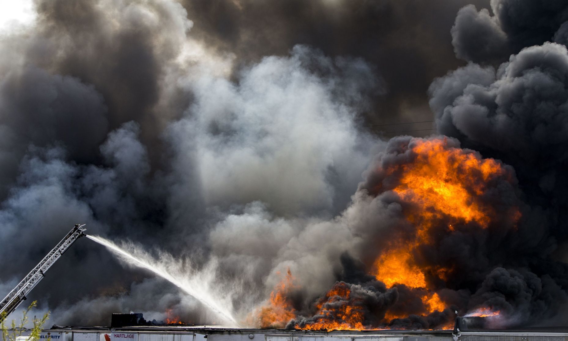 Large fire rolls through warehouse